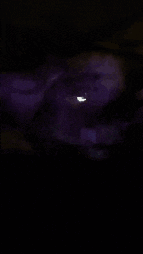 a dark room with purple lights coming out of the ceiling