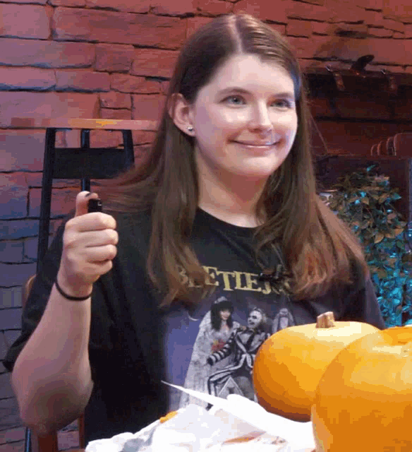 a woman wearing a black shirt that says beetlejuice