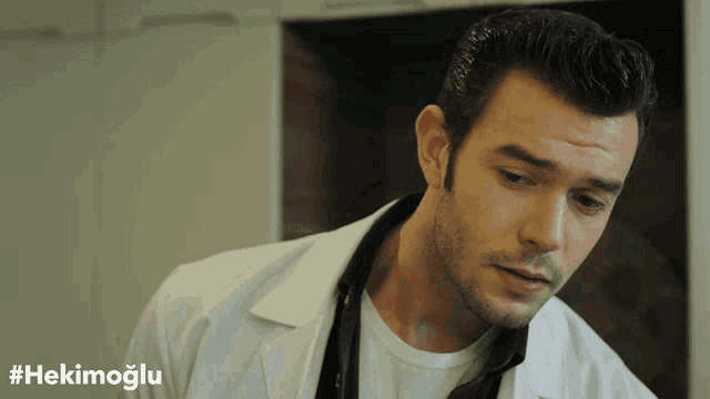 a man in a white lab coat with the hashtag #hekimoglu on the bottom