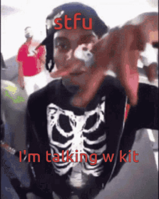 a man in a skeleton shirt is talking to someone