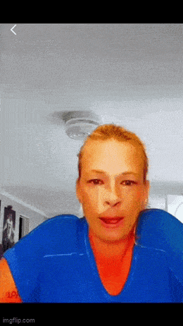 a woman is wearing a blue shirt with a red collar