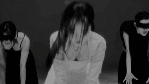 a group of women are dancing in a black and white photo