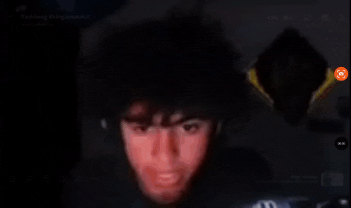 a blurred image of a person 's face with a pause button