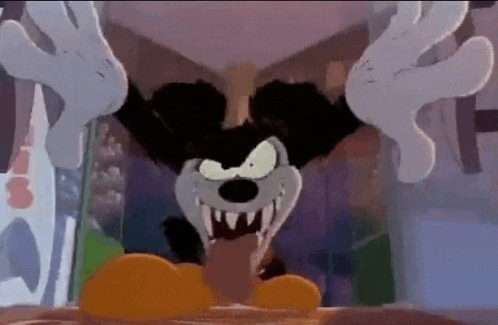 mickey mouse is a cartoon character with a very scary face and sharp teeth .