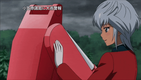 a girl in a red jacket is touching a red object with chinese writing on the bottom