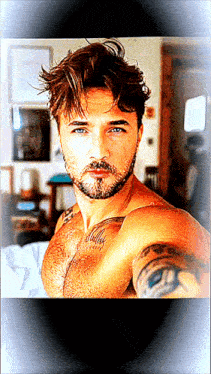 a shirtless man with a beard has a tattoo on his chest that says ' billy '