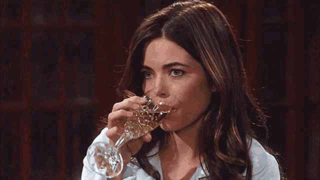 a woman is holding a glass of champagne in her hand