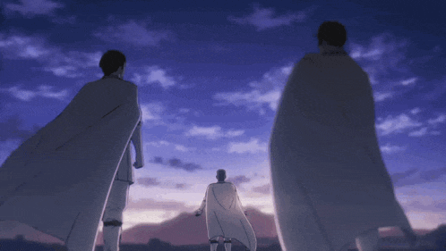 three men in white capes are standing in front of a sunset sky