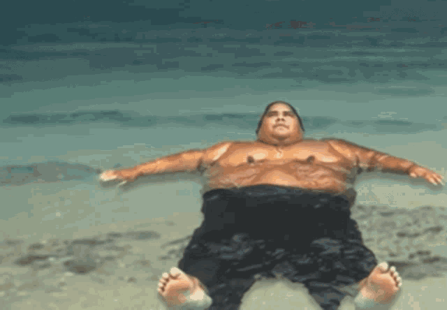 a man is laying on his back in the water