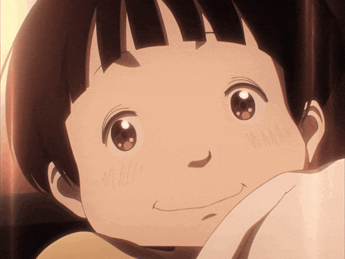 a close up of a child 's face with a smiling expression