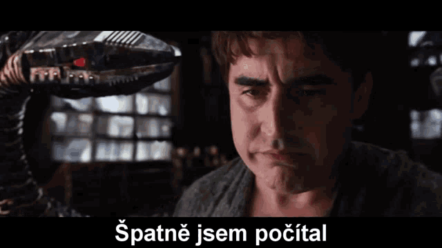 a man in a dark room with a caption that says spatne jsem pocitat