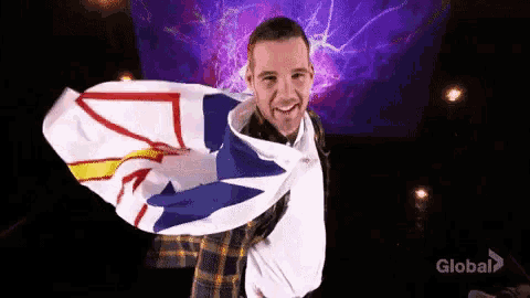a man in a plaid shirt is holding a canadian flag