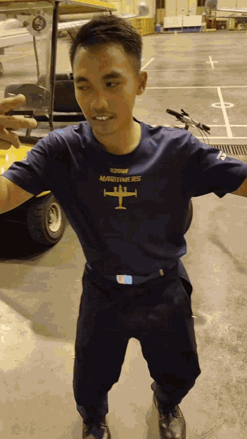 a man wearing a blue shirt that says maritime rs on it