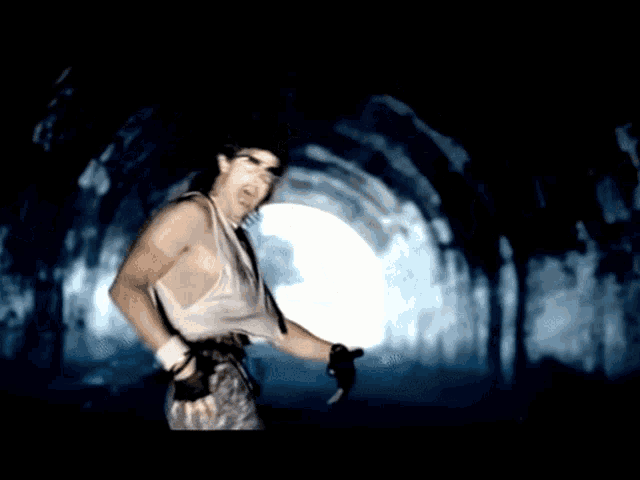 a man in a white tank top is running through a dark tunnel