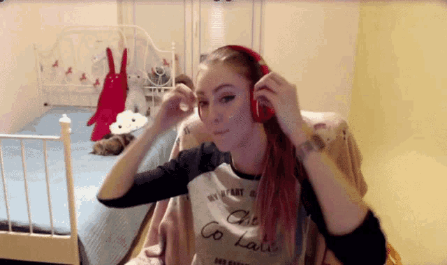 a girl wearing headphones and a shirt that says " my heart is chic "