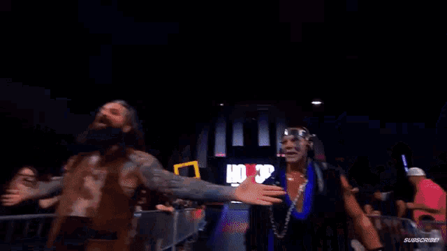 a man with a beard is screaming in a dark room with a sign that says subscribe