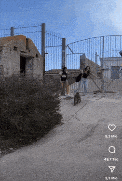 two women standing in front of a fence with one wearing a shirt that says ' i love you '