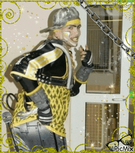 a picture of a man in a yellow and black outfit with a chain around his neck