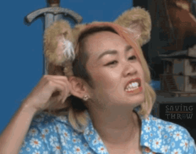 a woman wearing a teddy bear headband looks angry