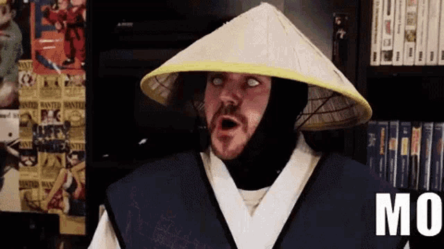 a man wearing a conical hat with the word mu written on it