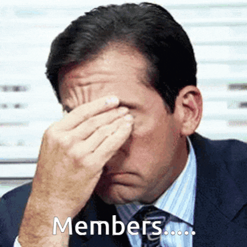 a man in a suit and tie is covering his face with his hands and the words members are above him .