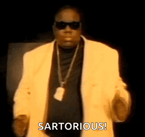 a man wearing sunglasses and a yellow jacket is dancing and says sartorious .