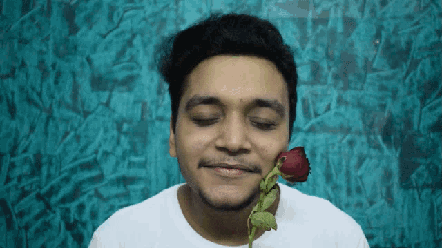 a man holding a red rose in his mouth