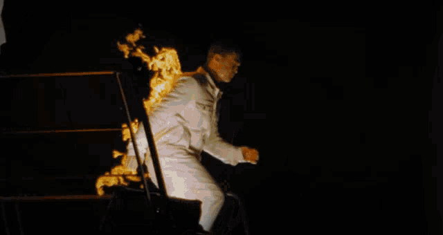 a person is on fire and is jumping out of a doorway