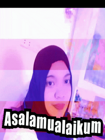 a woman wearing a hijab is standing in front of a sign that says ' assalamualaikum '