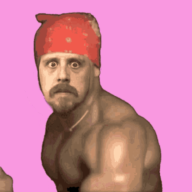 a shirtless man wearing a red bandana with a cat on it