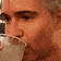 a man is drinking a glass of water with a straw .