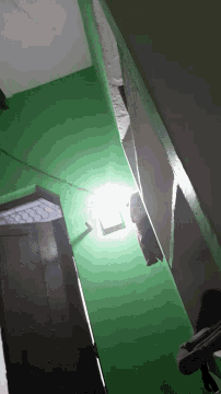 a room with a green wall and a light on
