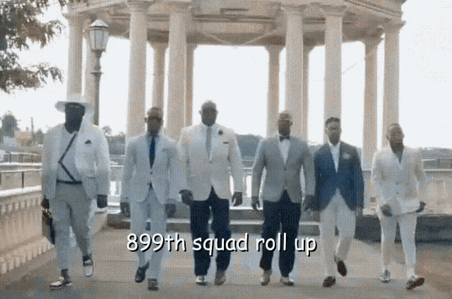 a group of men in suits are walking down a sidewalk with the caption " 899th squad roll up "