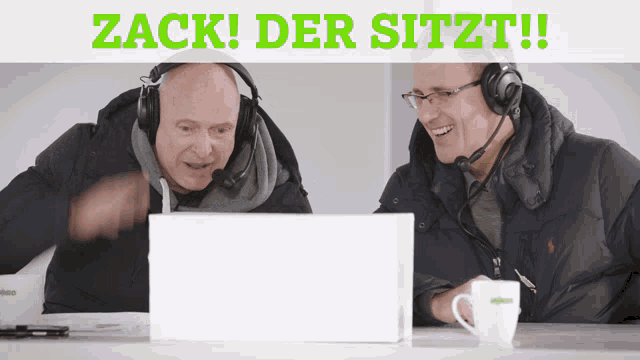 two men wearing headphones are sitting in front of a laptop with the words zack der sitzt on the bottom