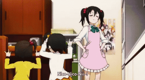 a girl in a pink apron is standing next to two other girls and says nico-nico-nii