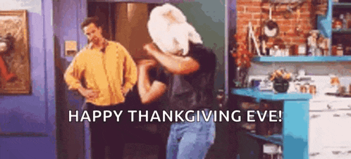 a man is holding a turkey over his head while another man stands behind him .