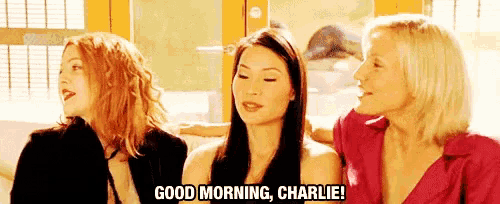 three women are sitting next to each other on a couch and one of them is saying good morning charlie .