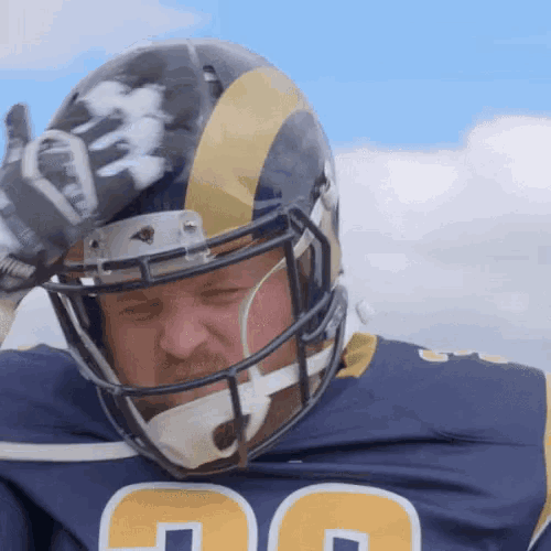 a football player wearing a helmet with the number 26 on his jersey