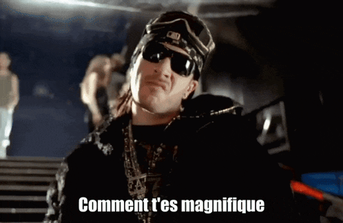 a man wearing sunglasses and a hat says " comment t'es magnifique "