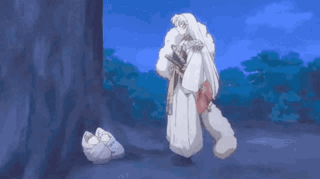 a samurai is standing next to a tree holding a sword and looking at a baby .