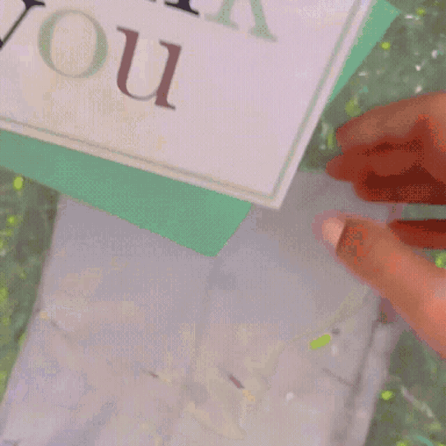 a person is holding a piece of paper that says you