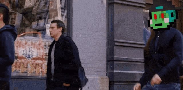 a man in a black jacket is walking down the street with a pixelated face on his head