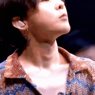 a close up of a person 's neck and ear while wearing earrings .