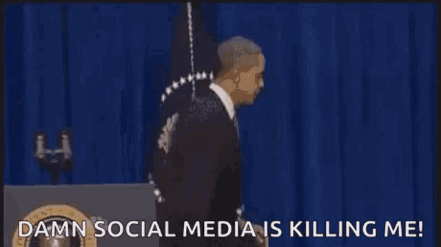 a man in a suit is walking out of a room with the words `` damn social media is killing me '' written on it .