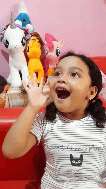 a little girl wearing a striped shirt that says sweet is my mom