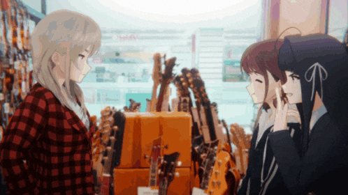 a girl in a red plaid shirt talks to two other girls