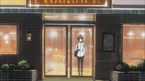a woman is standing in front of a building with a sign that says ' l' aquatic ' on it