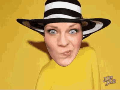a woman wearing a black and white striped hat and a pink shirt