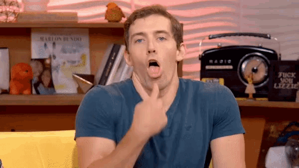 a man making a face in front of a radio that says " fuck you lizzie "