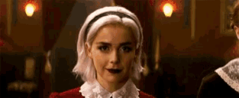 a close up of a woman 's face with a headband on her head .